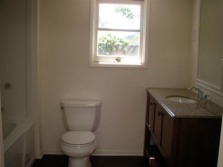 81 Valley Road Oak View, CA 93022 - Photo 9 of 11 a bathroom with a granite countertop toilet a sink and a window