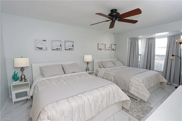 a bedroom with two beds and a chandelier