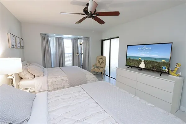 a bedroom with a bed and a tv on the dresser