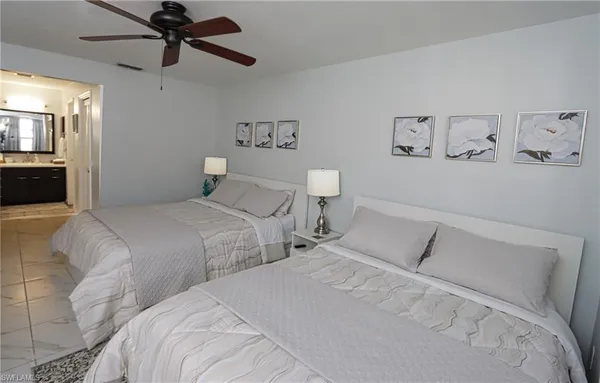 a bedroom with a large bed and a chandelier