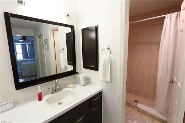 a bathroom with a sink vanity and mirror