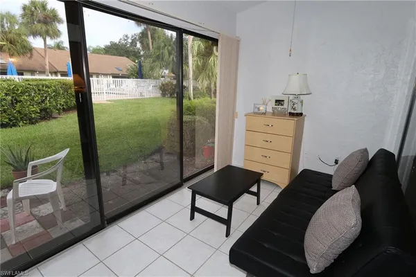 a bedroom with a bed and large window