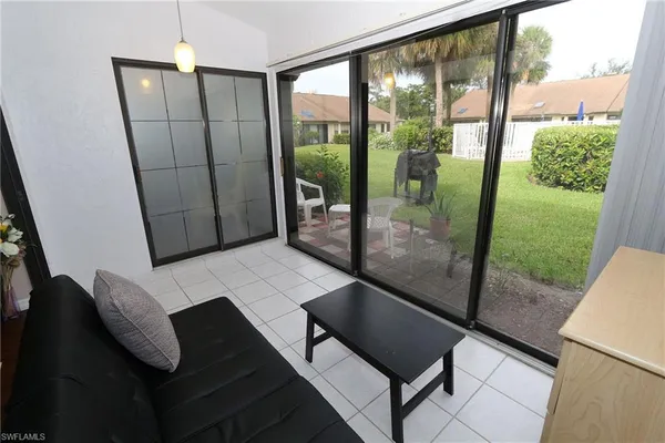 a view of a balcony with chair and floor to ceiling window