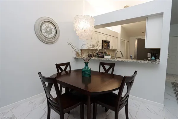 a view of a dining room with furniture and a chandelier