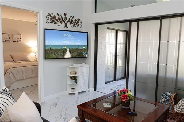 a living room with furniture and a flat screen tv