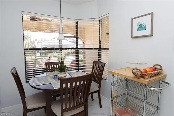 a view of a dining room with furniture window and outside view