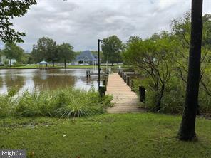 5625 Gunner Run Road Churchton, MD 20733 - Photo 3 of 4 a view of a lake with a yard and trees