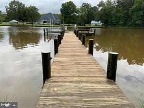 5625 Gunner Run Road Churchton, MD 20733 - Photo 4 of 4 a wooden pier with boats in a lake