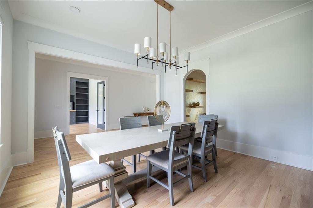 3470 Hamilton Mill Road Buford, GA 30519 - Photo 11 of 39 a view of a dining room with furniture a chandelier and wooden floor