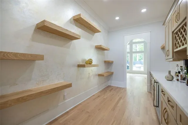 a kitchen with a wooden floor and a window