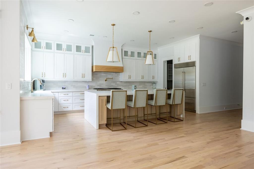 3470 Hamilton Mill Road Buford, GA 30519 - Photo 18 of 39 a kitchen with stainless steel appliances kitchen island granite countertop a refrigerator and cabinets