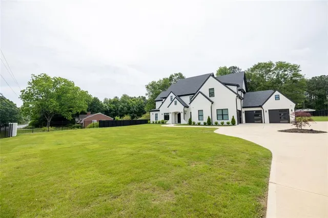 a front view of a house with a garden