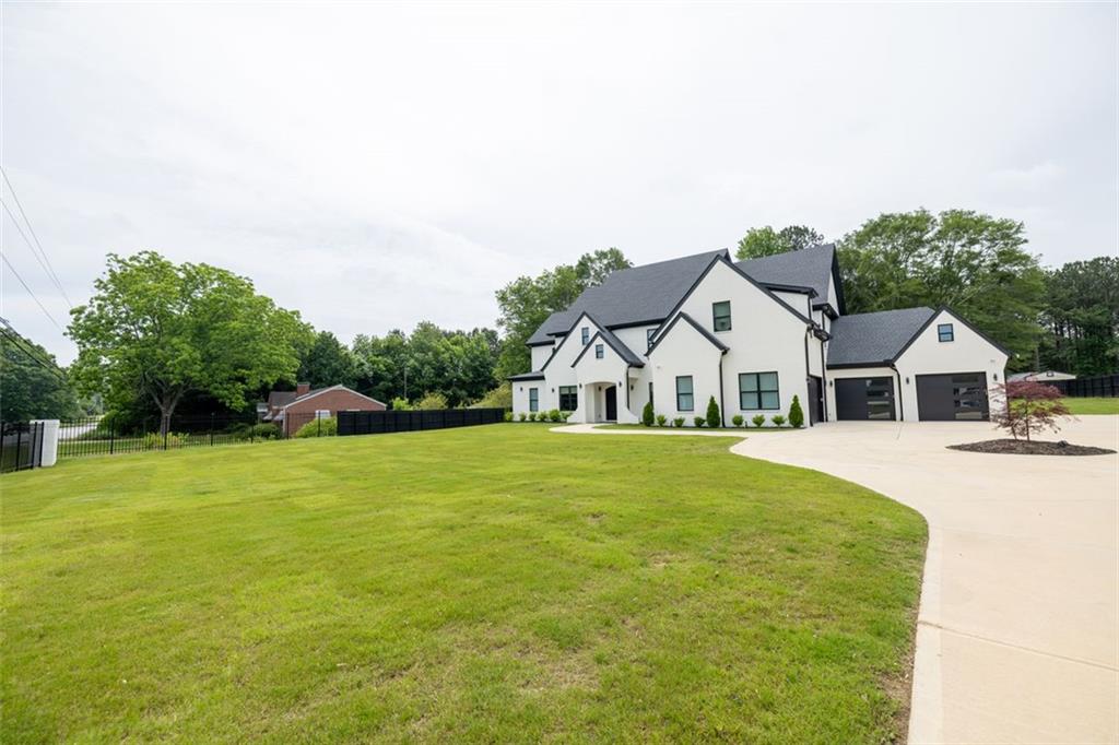 3470 Hamilton Mill Road Buford, GA 30519 - Photo 2 of 39 a front view of a house with a garden