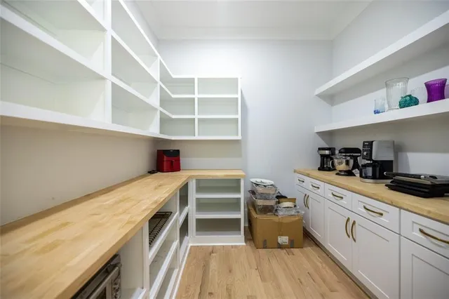 a kitchen with a cabinets and wooden floor