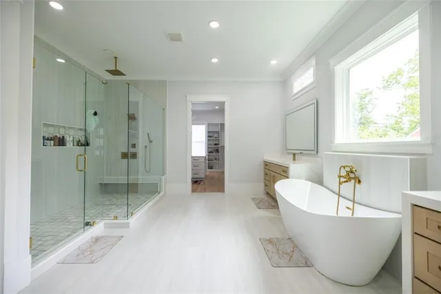 a bathroom with a bathtub and a shower