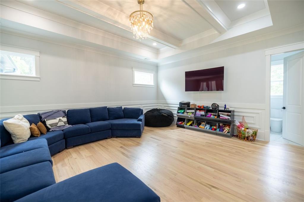 3470 Hamilton Mill Road Buford, GA 30519 - Photo 32 of 39 a living room with furniture a wooden floor and a ceiling fan