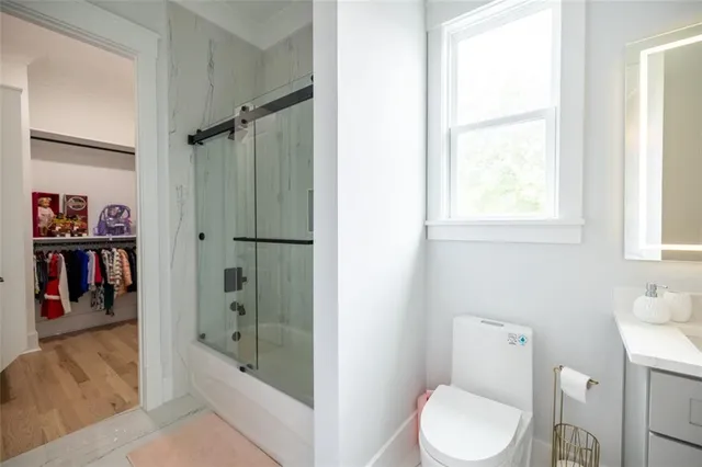 a bathroom with a toilet and a shower