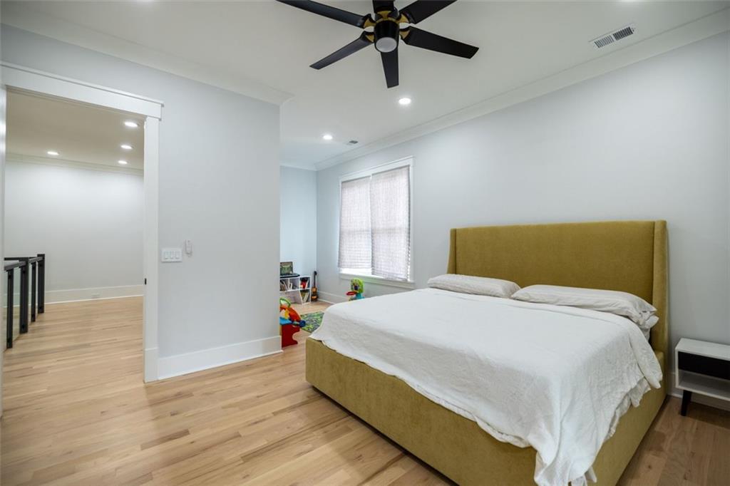 3470 Hamilton Mill Road Buford, GA 30519 - Photo 35 of 39 a bedroom with a bed and a chandelier