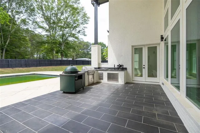 a view of a swimming pool with a yard and seating space