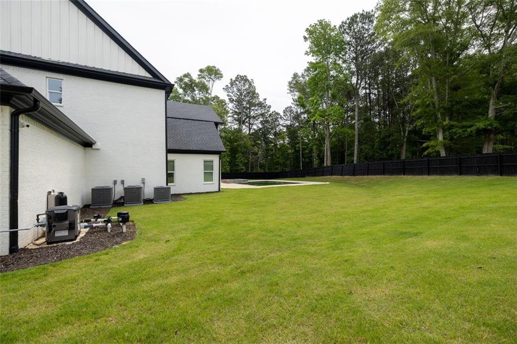 3470 Hamilton Mill Road Buford, GA 30519 - Photo 4 of 39 a view of a patio with table and chairs and potted plants with wooden fence