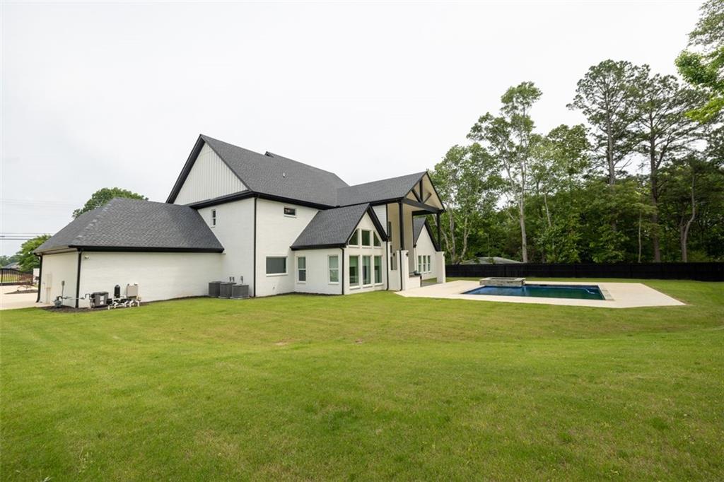 3470 Hamilton Mill Road Buford, GA 30519 - Photo 5 of 39 a view of a house with a big yard and large trees