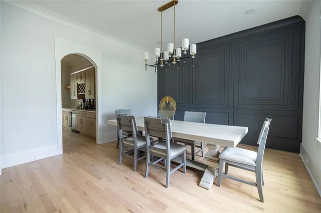 a view of a dining room with furniture and chandelier