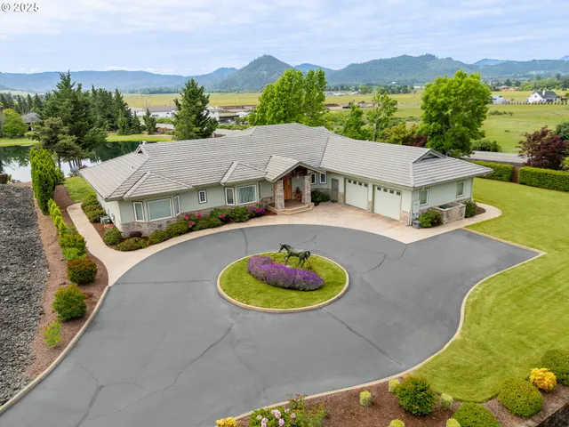 an aerial view of a house with a garden and a swimming pool