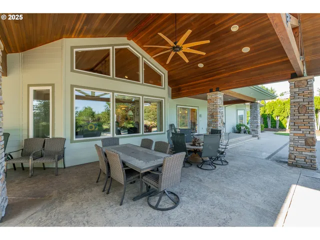 a view of a patio with table and chairs