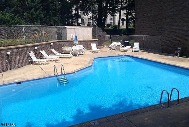365 River Road, Unit E Nutley, NJ 07110 - Photo 14 of 14 a view of a backyard with table and chairs