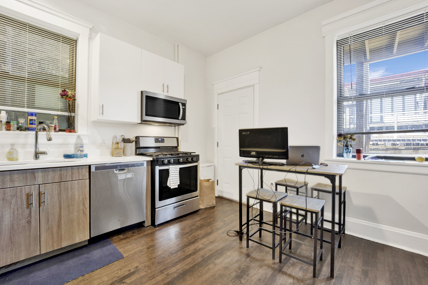 3932 North Sheridan Road, Unit 2 Chicago, IL 60613 - Photo 3 of 9 a kitchen with a stove a sink and a microwave