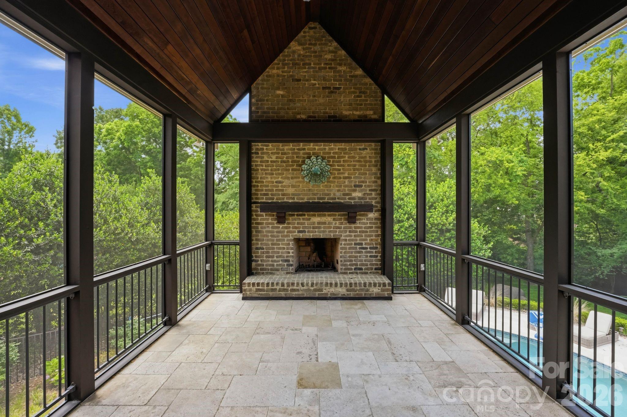7416 Lee Rea Road Charlotte, NC 28226 - Photo 7 of 48 a living room with a fireplace and a floor to ceiling window