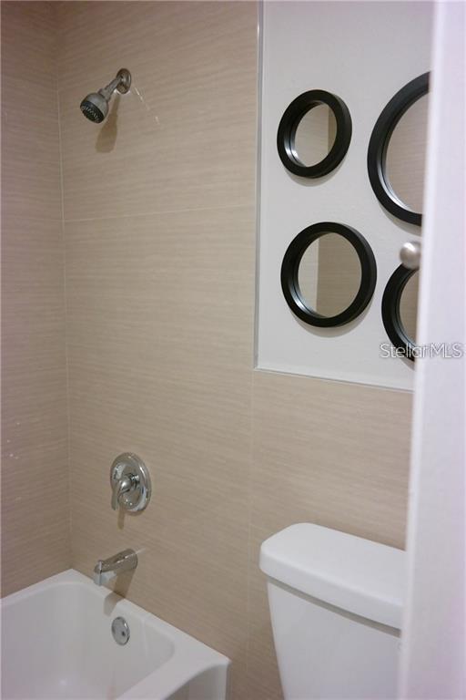 224 Afton Square, Unit 104 Altamonte Springs, FL 32714 - Photo 11 of 13 a bathroom with a granite countertop sink and a mirror