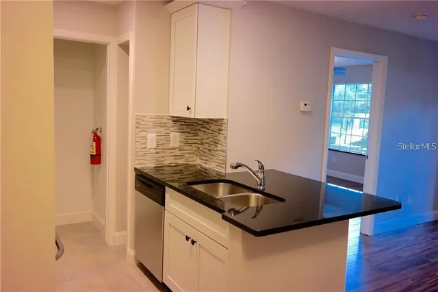 a kitchen with a sink and cabinets