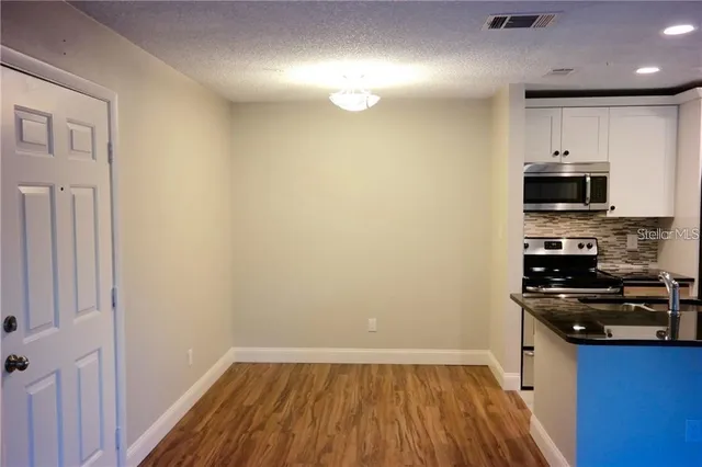 a kitchen with sink a stove and cabinets