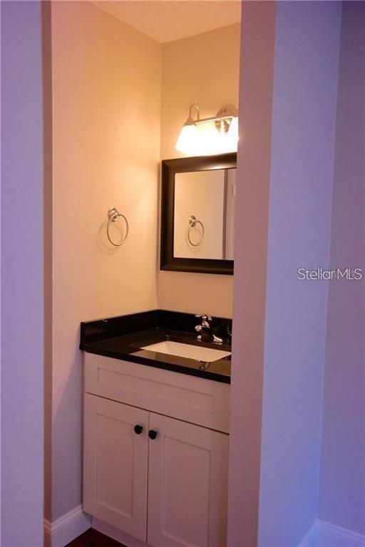 224 Afton Square, Unit 104 Altamonte Springs, FL 32714 - Photo 9 of 13 a bathroom with a sink and a mirror