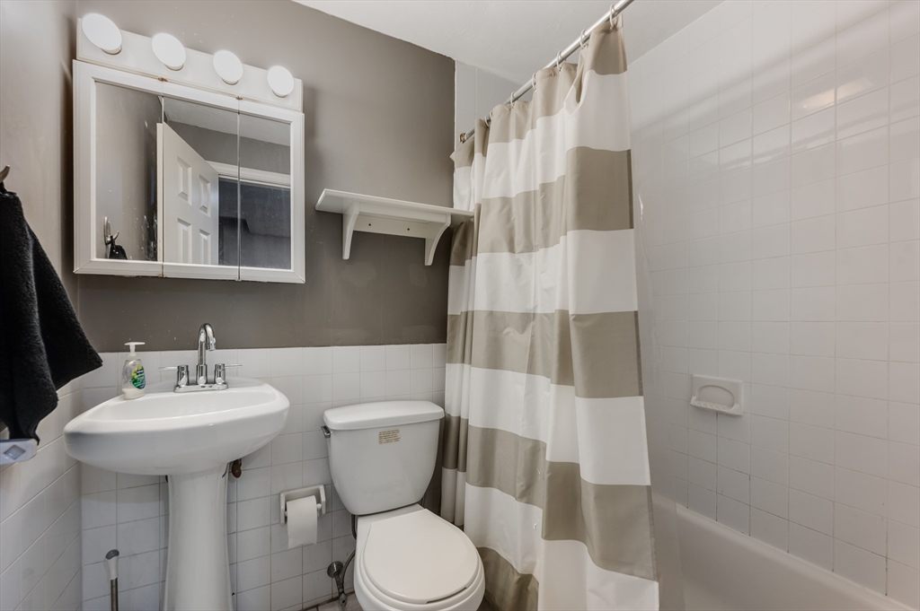 21 Aberdeen Street, Unit B Boston, MA 02215 - Photo 11 of 13 a bathroom with a sink toilet and shower