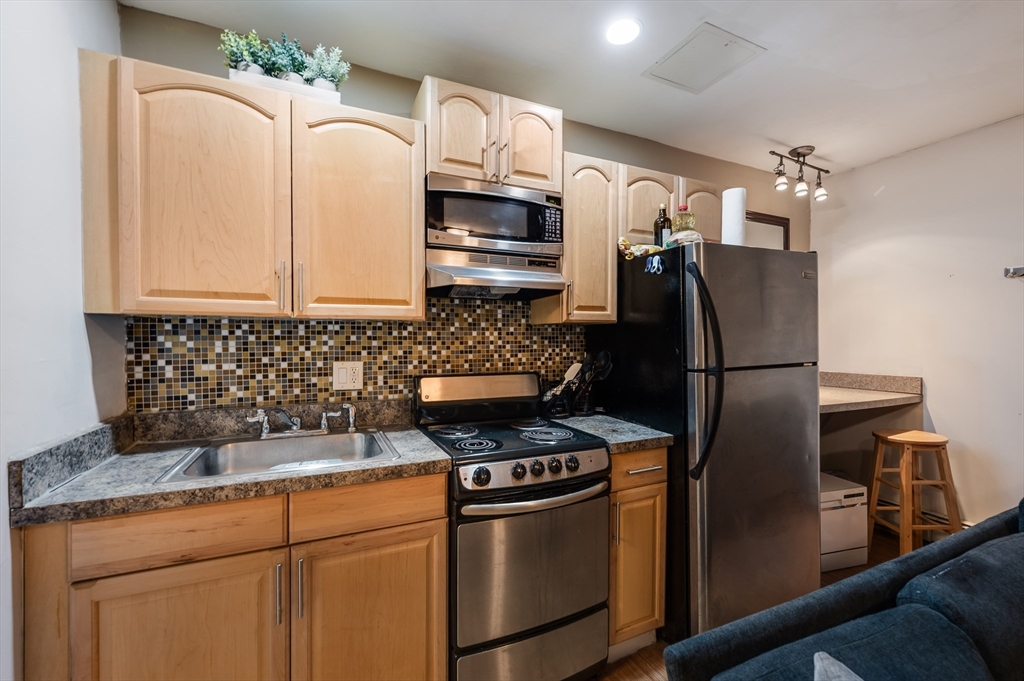 21 Aberdeen Street, Unit B Boston, MA 02215 - Photo 3 of 13 a kitchen with stainless steel appliances granite countertop a refrigerator a stove and a sink