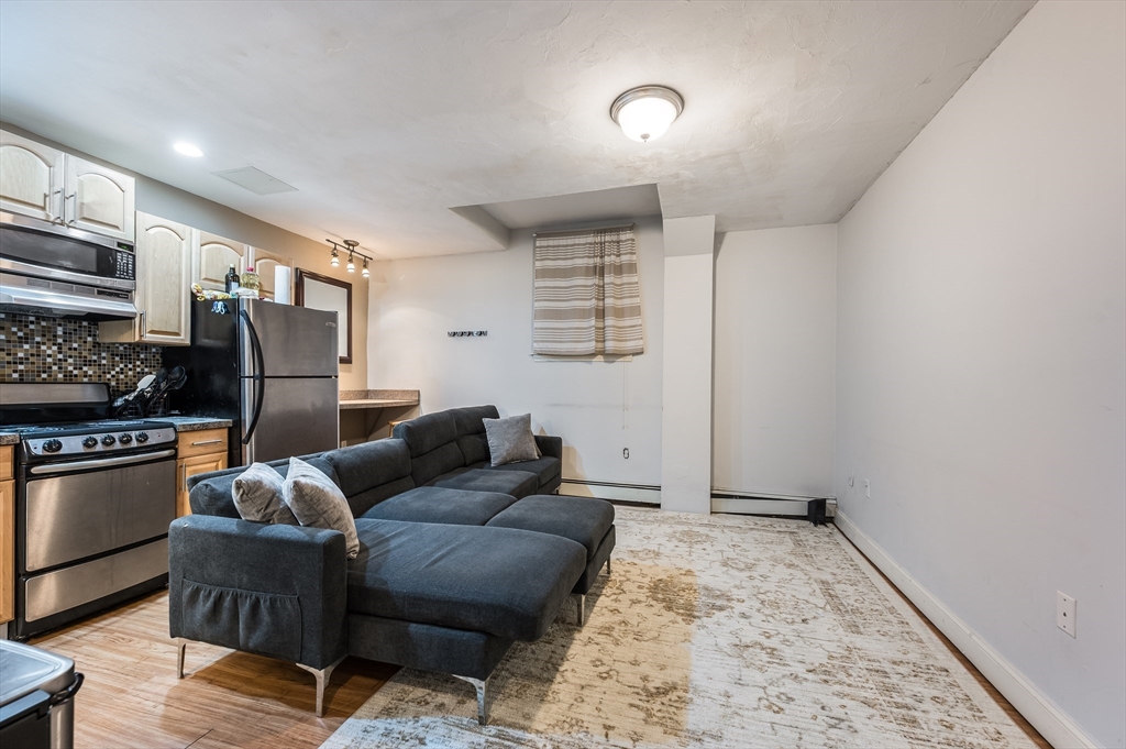 21 Aberdeen Street, Unit B Boston, MA 02215 - Photo 4 of 13 a living room with furniture and a rug