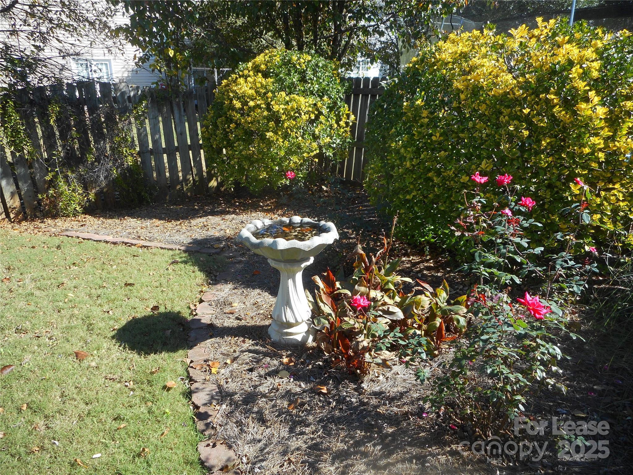 17207 Overstone Court Charlotte, NC 28277 - Photo 14 of 28 a bunch of flowers and trees with wooden fence