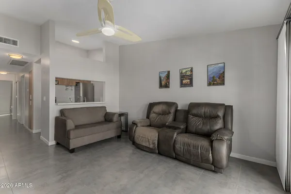 a living room with furniture and a lamp