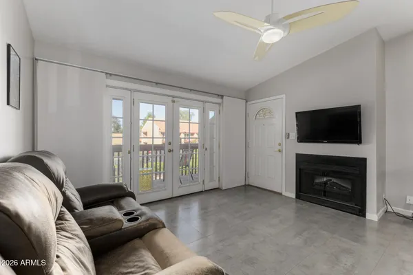 a living room with furniture a flat screen tv and a fireplace