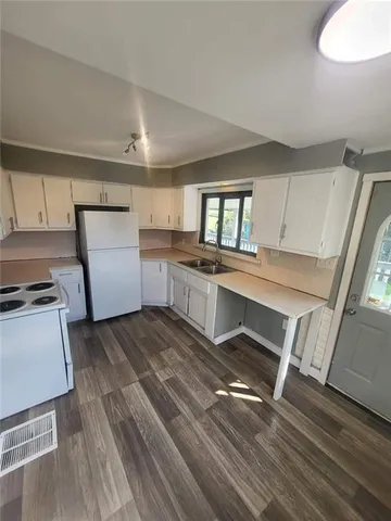 a kitchen with a sink stove and refrigerator