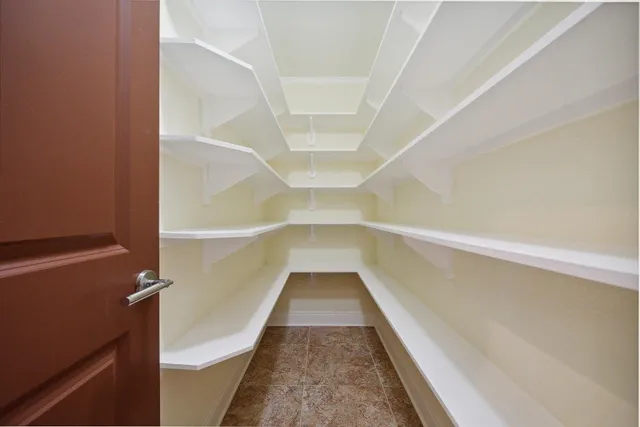 a bedroom with a large bed a flat tv screen and a fireplace