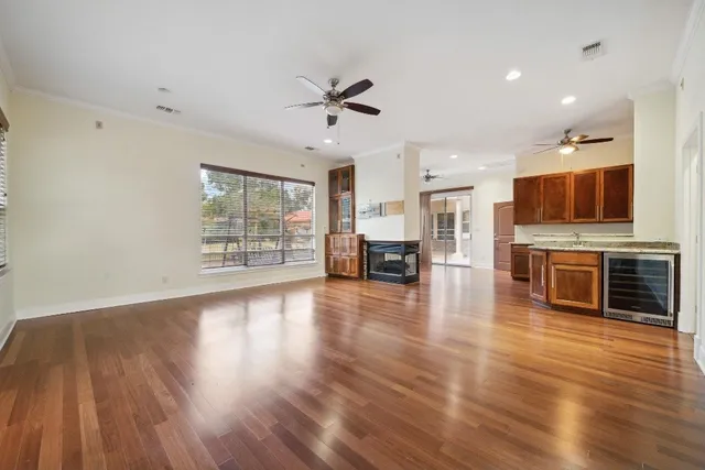 a large kitchen with a large counter top stainless steel appliances and cabinets