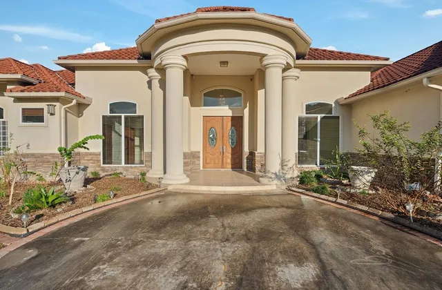a view of a house with potted plants