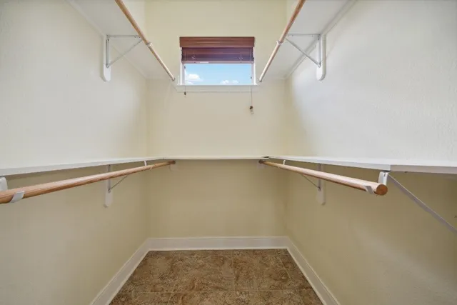 a bathroom with a granite countertop toilet sink and mirror
