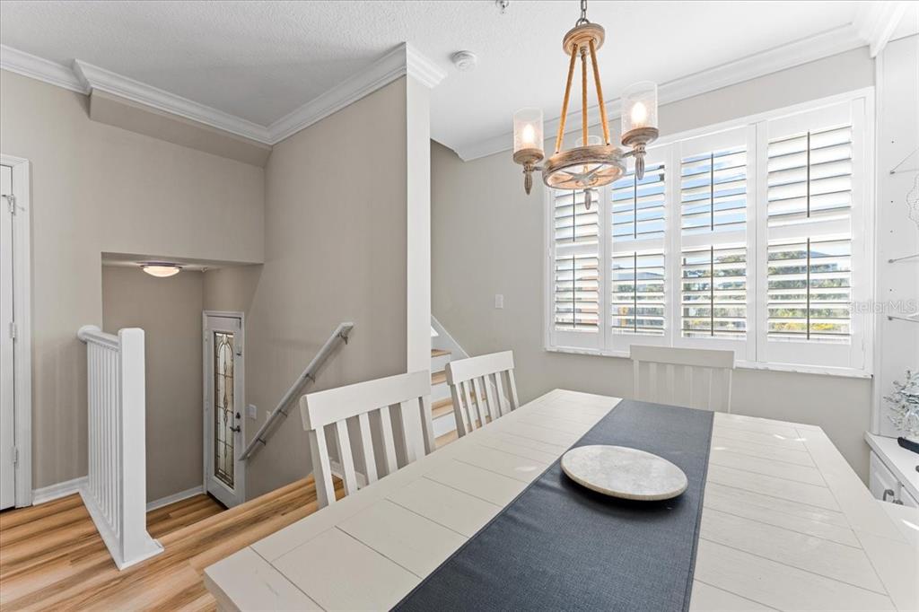 5627 Red Snapper Court New Port Richey, FL 34652 - Photo 13 of 54 a view of a dining room with furniture and a chandelier