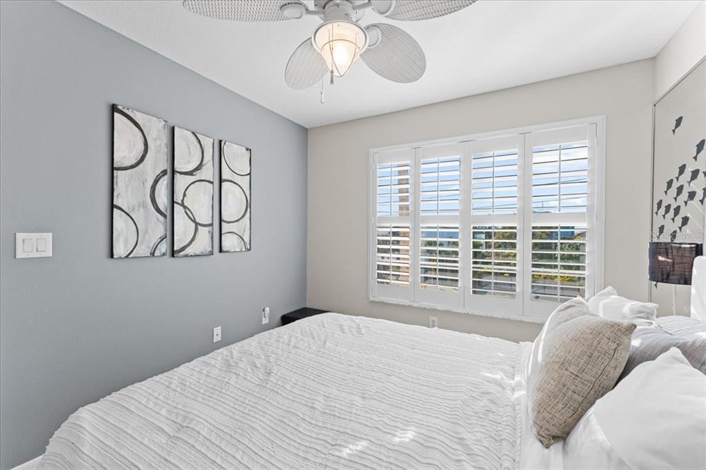 5627 Red Snapper Court New Port Richey, FL 34652 - Photo 31 of 54 a bedroom with a bed and a chandelier