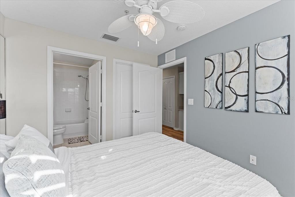 5627 Red Snapper Court New Port Richey, FL 34652 - Photo 32 of 54 a bedroom with a bed and a chandelier