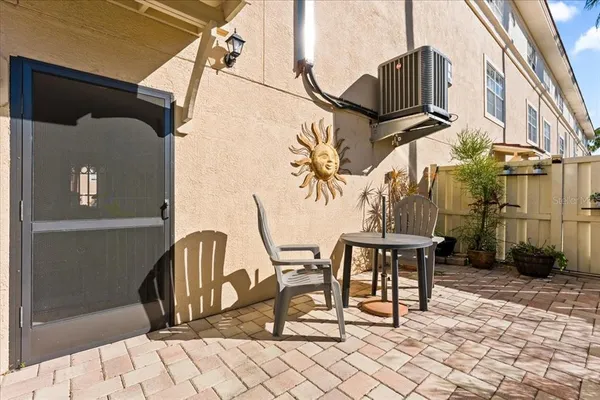a living room with stainless steel appliances furniture and kitchen view